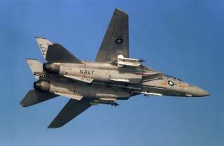 A U.S. Navy Grumman Grumman F-14A-85-GR Tomcat (BuNo 159595) from fighter squadron VF-143 Pukin' Dogs in flight on 20 April 1987, armed with three AIM-7 Sparrow and four AIM-9L Sidewinder air-to-air missiles