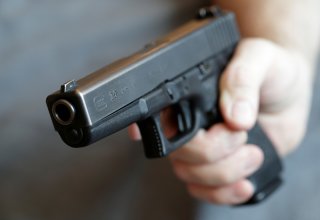 A gun owner displays a Glock 20, 10 mm Auto pistol in Vienna, Austria, March 22, 2018. REUTERS/Heinz-Peter Bader