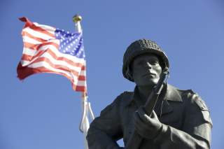 The statue of Maj. Dick Winters of Easy Company, 506th Parachute Infantry Regiment, 101st Airborne Division, stands as reminder of the sacrifice of the Greatest Generation near Utah Beach, Normandy, France, June 7, 2015. Over 380 service members from Euro