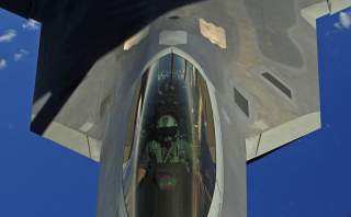 A U.S. Air Force F-22 Raptor pilot assigned to the 90th Fighter Squadron, Elmendorf Air Force Base, Alaska, receives fuel from a KC-135 Stratotanker with the 465 Air Refueling Squadron out of Tinker Air Force Base, Okla