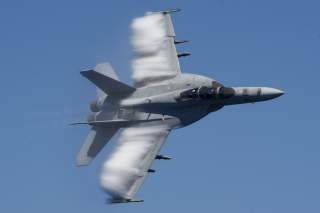  An F/A-18E Super Hornet performs a fly-by during a change of command ceremony for the 