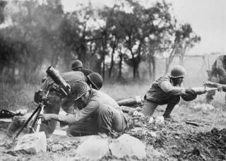 Members of a mortar company of the 92nd Division pass the ammunition and heave it over at the Germans in an almost endless stream near Massa, Italy. This company is credited with liquidating several machine gun nests. Wikimedia Commons