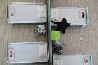 A medical aid worker setting up and installing a bed at a shopping mall, one of Iran's largest, which has been turned into a centre to receive patients suffering from the coronavirus disease (COVID-19), in Tehran, Iran, April 4, 2020. WANA (West Asia News