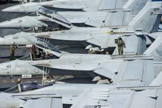 U.S. Sailors prepare for flight operations on the aircraft carrier USS George Washington (CVN 73) in the East China Sea July 28, 2014. 