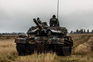 A Romanian TR-85 tank and tanker on a training ground in Romania. US troops are currently on deployment in Romania as part of Operation Atlantic Resolve.