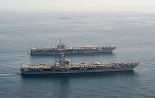 ARABIAN SEA (March 18, 2020) The aircraft carriers USS Dwight D. Eisenhower (CVN 69), front, and USS Harry S. Truman (CVN 75), and the guided-missile destroyer USS Lassen (DDG 82) transit the Arabian Sea, March 18, 2020. The Harry S. Truman Carrier Strike