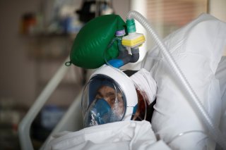 A patient suffering from coronavirus disease (COVID-19) wears a full-face Easybreath snorkelling mask given by sport chain Decathlon and turned into a ventilator for coronavirus treatment at the intensive care unit at Ambroise Pare clinic in Neuilly-sur-S