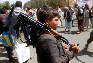 A boy carries a weapon as he and Houthi supporters are seen during a gathering in Sanaa, Yemen April 2, 2020. REUTERS/Mohamed al-Sayaghi