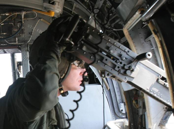A CH-46E Sea Knight crew chief with Marine Medium Helicopter Squadron 261 mans an XM-214 .50 caliber machine gun while airborne during a helicopter-borne training exercise, aboard Camp Lejeune, N.C., March 6, 2007.