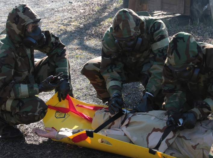 Marines from Marine Forces Reserve rescue and extract a victim from a contaminated area during a chemical, biological, radiological and nuclear defense training simulation aboard Naval Air Station Joint Reserve Base New Orleans, Feb. 5, 2015.