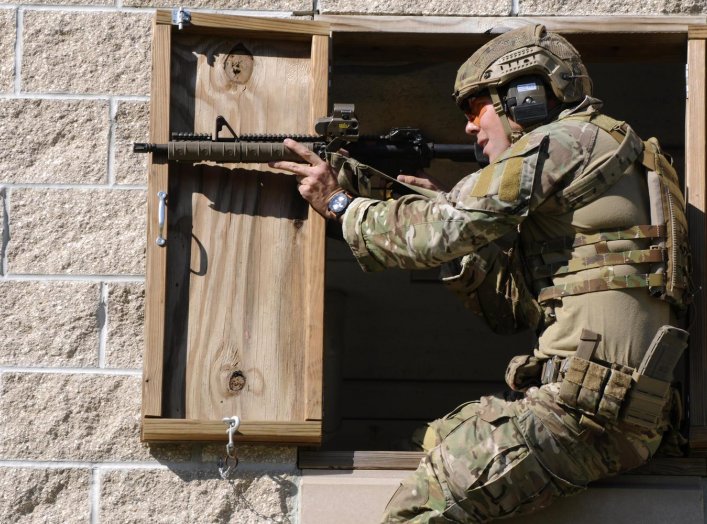 A Green Beret soldier fires a rifle during a stress shoot competition on Eglin Air Force Base, Fla., Oct. 15, 2015. U.S. Army photo by Staff Sgt. William Waller.