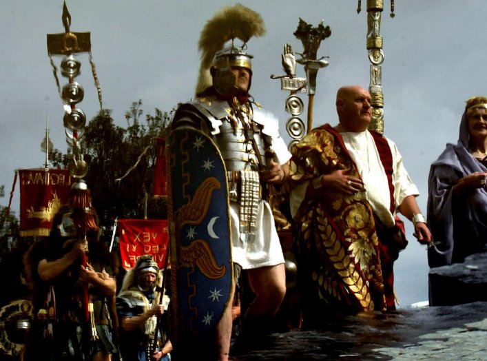 Englishmen from Newcastle, dressed as ancient Romans of the II Augusta Roman Legion, are reflected in a puddle as they march during a parade in Rome April 18, 2004. REUTERS/Max Rossi MR/CRB