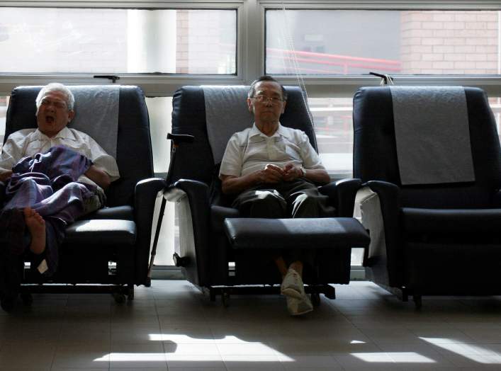 Patients Chung Kong Tuck (L), 72, and Wong Hong Jee, 85, rest at the HCA Day Care Centre in Singapore September 19, 2007. Every week, around 50 elderly terminally ill patients spend the day at the centre, where they participate in rehabilitative and socia