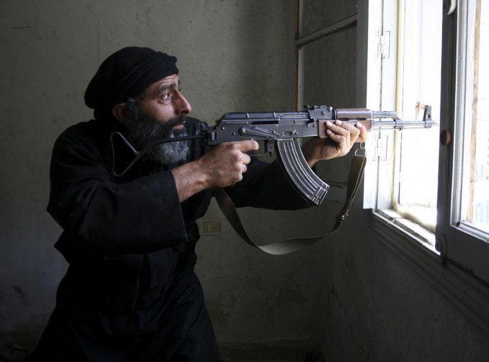 A Free Syrian Army fighter aims his AK-47 rifle through a window in Aleppo's Salaheddine neighbourhood April 28, 2013. Picture taken April 28, 2013. REUTERS/Aref Hretani 