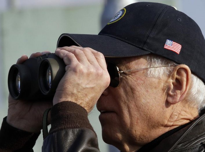 U.S. Vice President Joe Biden looks through binoculars to see North Korea from Observation Post Ouellette during a tour of the Demilitarized Zone (DMZ), the military border separating the two Koreas, in Panmunjom, December 7, 2013. REUTERS/Lee Jin-man/Poo