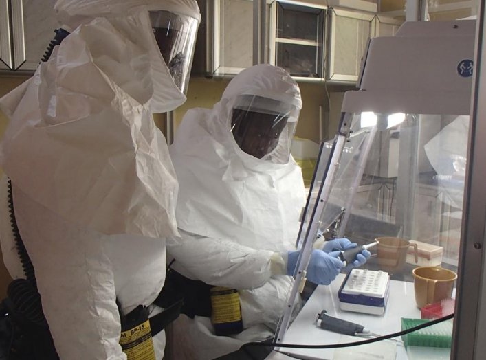 A U.S. Army Medical Research Institute of Infectious Diseases (USAMRIID) technician sets up an assay for Ebola within a containment laboratory in this undated handout picture. REUTERS/USAMRIID/Randal Schoepp/Handout via Reuters