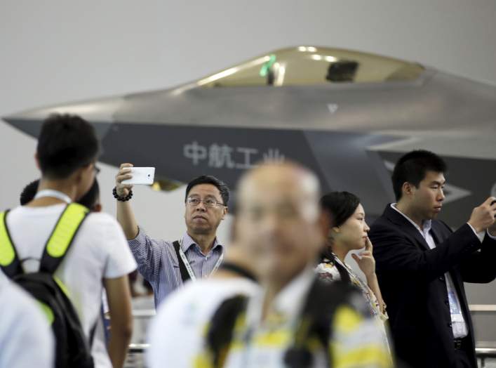 A visitor takes a selfie in front of a model of J-31 stealth fighter at Aviation Industry Corporation of China (AVIC)'s booth at the Aviation Expo China 2015, in Beijing, China, September 16, 2015.