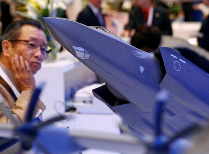 A man looks at a model of Lockheed Martin's F-35 fighter jet during Japan Aerospace 2016 air show in Tokyo, Japan, october 12, 2016. REUTERS/Kim Kyung-Hoon