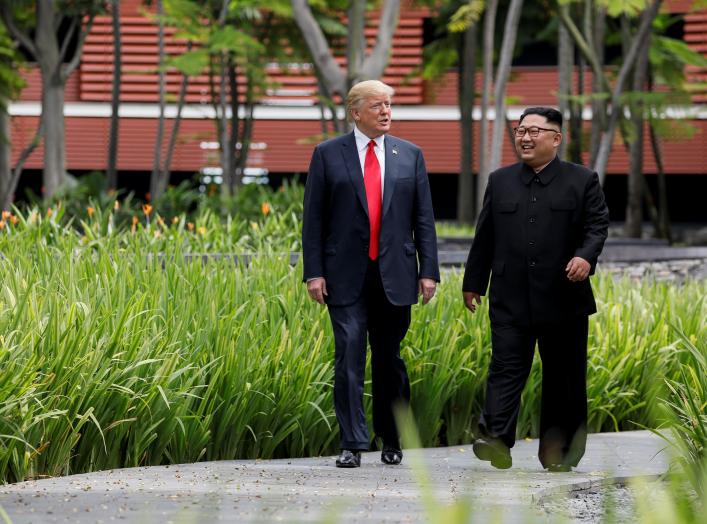 U.S. President Donald Trump and North Korea's leader Kim Jong Un walk together before their working lunch during their summit at the Capella Hotel on the resort island of Sentosa, Singapore June 12, 2018. Picture taken June 12, 2018. REUTERS/Jonathan Erns