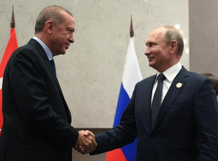 Russia's President Vladimir Putin (R) shakes hands with his Turkish counterpart Tayyip Erdogan during a meeting on the sidelines of the BRICS summit in Johannesburg, South Africa July 26, 2018. Sputnik/Vladimir Astapkovich/Kremlin