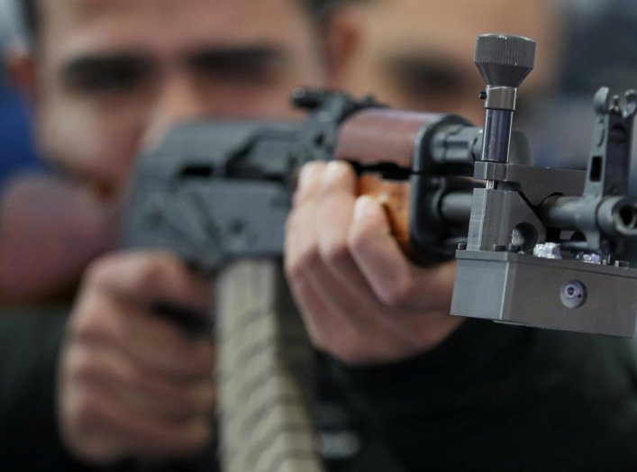 A visitor holds an AK-47 at the Egytian stand during the last day of Egypt Defense Expo, showcasing military systems and hardware, in Cairo, Egypt, December 5, 2018. REUTERS/Mohamed Abd El Ghany