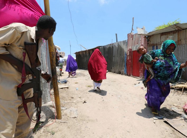 A Somali soldier holds position as civilians evacuate from the scene of a suicide explosion after al-Shabaab militia stormed a government building in Mogadishu, Somalia March 23, 2019. REUTERS/Feisal Omar TPX IMAGES OF THE DAY