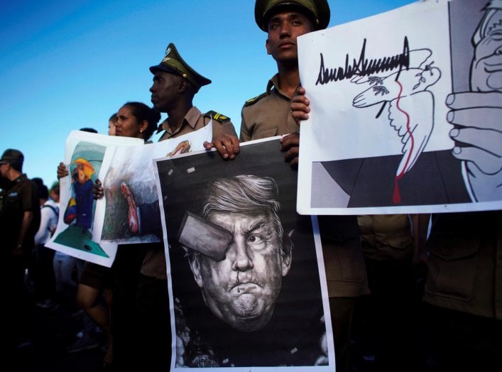 Cuban soldiers carry images depicting U.S. President Donald Trump during a May Day rally in Havana, Cuba May 1, 2019. REUTERS/Alexandre Meneghini
