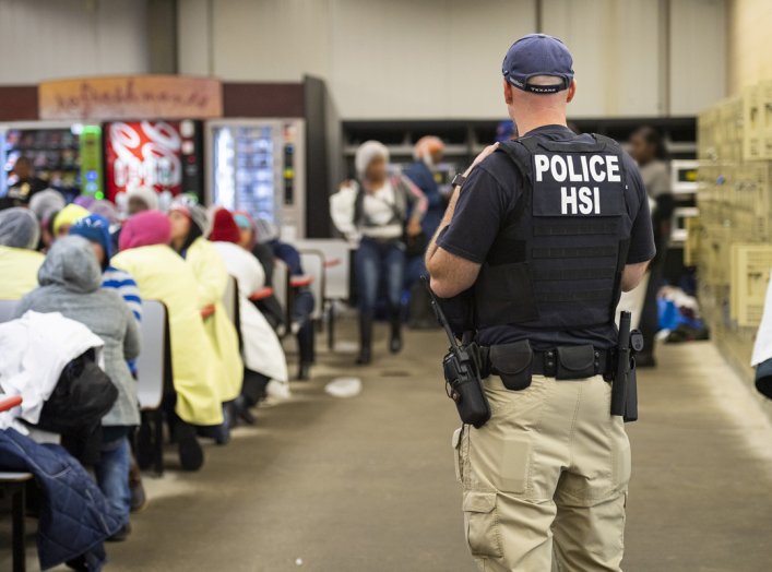 Homeland Security Investigations (HSI) officers from Immigration and Customs Enforcement (ICE) look on after executing search warrants and making some arrests at an agricultural processing facility in Canton, Mississippi, U.S. in this August 7, 2019 hando