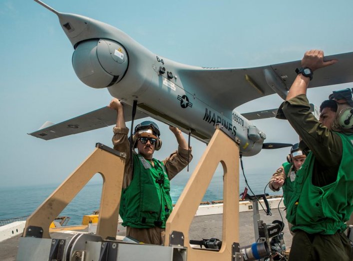 U.S. Navy Marines lift an RQ-21A Blackjack unmanned aerial system (UAS) onto a launcher before flight operations aboard the amphibious transport dock ship USS John P. Murtha (LPD 26) in the Gulf, in this undated handout picture released by U.S. Navy on Ju