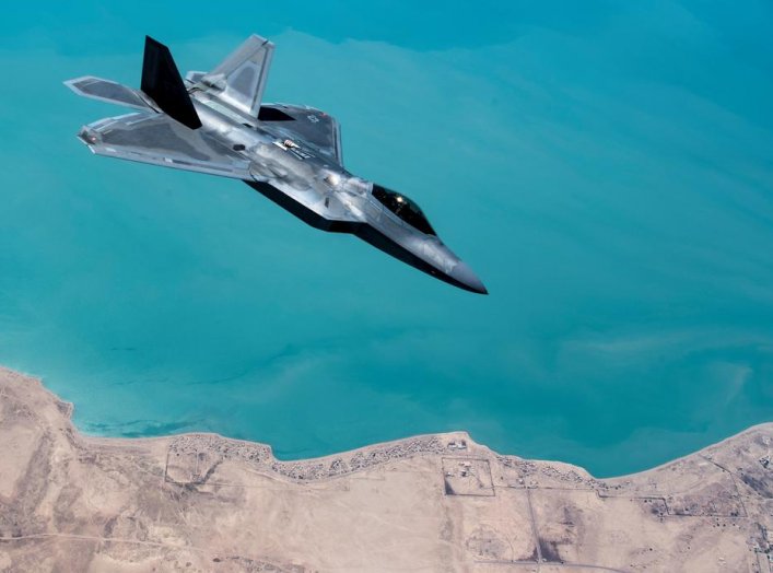 A U.S. F-22 Raptor, based out of Al Udeid Base in Doha, Qatar, receives fuel from a 28th Expeditionary Air Refuelling Squadron KC-135 Stratotanker during a combat air patrol mission over an undisclosed location in Southwest Asia, in this picture taken Sep