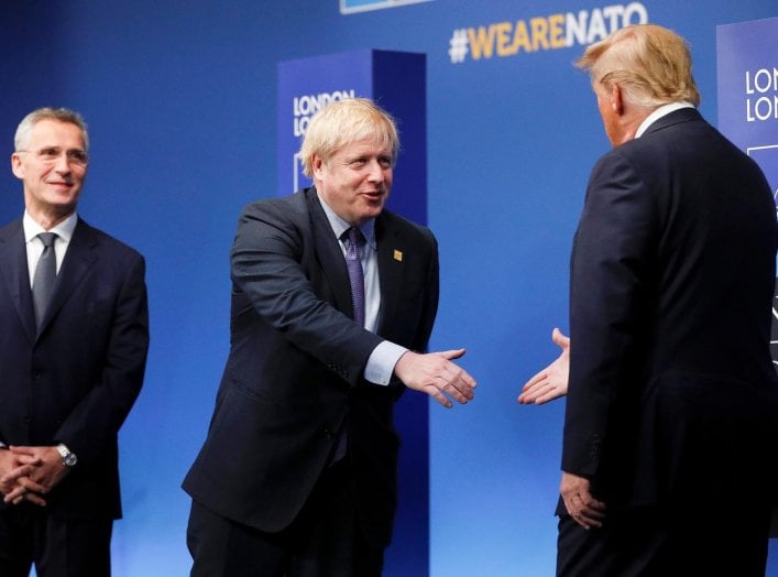 NATO Secretary General Jens Stoltenberg and Britain's Prime Minister Boris Johnson greet U.S. President Donald Trump at the annual NATO heads of government summit at the Grove hotel in Watford, Britain December 4, 2019. REUTERS/Peter Nicholls/Pool