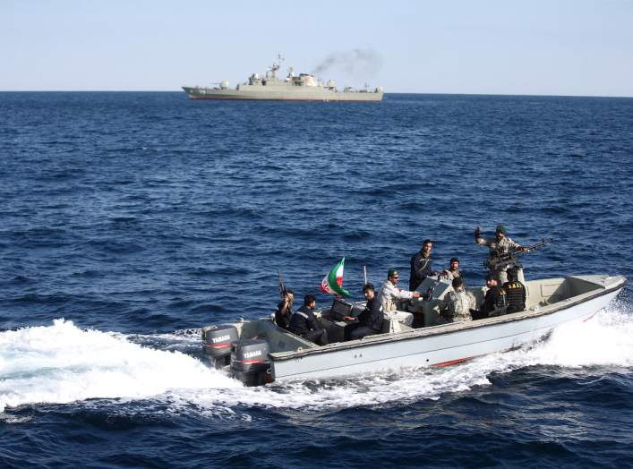 Iranian marine soldiers wave to the camera from a motor boat in the Sea of Oman during the third day of joint Iran, Russia and China naval war games in Chabahar port, at the Sea of Oman, Iran, December 29, 2019. Mohsen Ataei/Fars news agency/WANA (West As