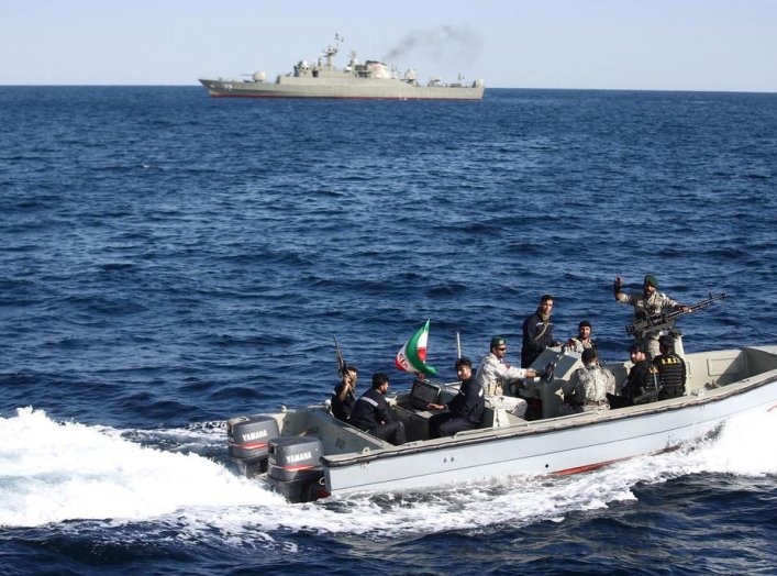 Iranian marine soldiers wave to the camera from a motor boat in the Sea of Oman during the third day of joint Iran, Russia and China naval war games in Chabahar port, at the Sea of Oman, Iran, December 29, 2019. Mohsen Ataei/Fars news agency/WANA (West As