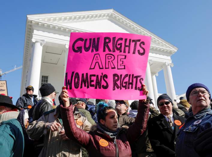 A activist holds up a sign supporting gun rights for women during a rally inside the no-gun zone in front of the Virginia State Capitol building in Richmond, Virginia, U.S. January 20, 2020. REUTERS/Jonathan Drake