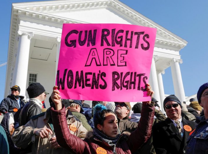 A activist holds up a sign supporting gun rights for women during a rally inside the no-gun zone in front of the Virginia State Capitol building in Richmond, Virginia, U.S. January 20, 2020. REUTERS/Jonathan Drake