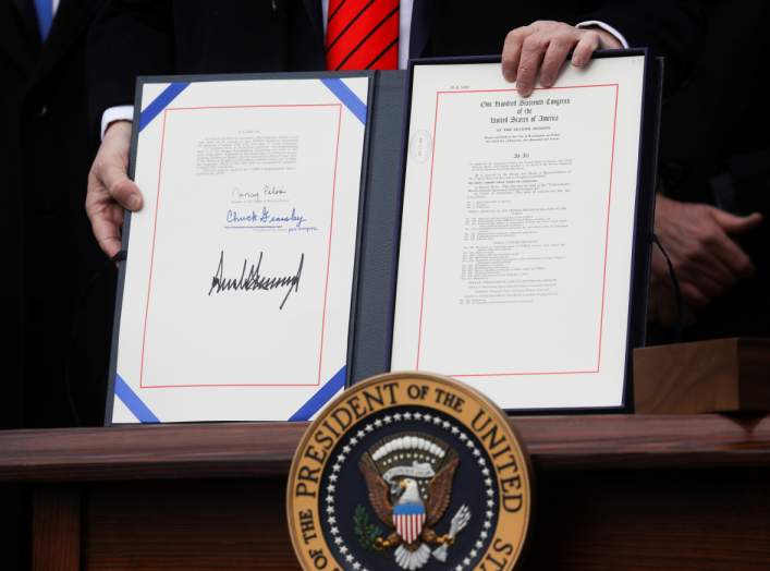 U.S. President Donald Trump shows off the United States-Mexico-Canada Trade Agreement (USMCA) after signing it on the South Lawn of the White House in Washington, U.S., January 29, 2020. REUTERS/Leah Millis