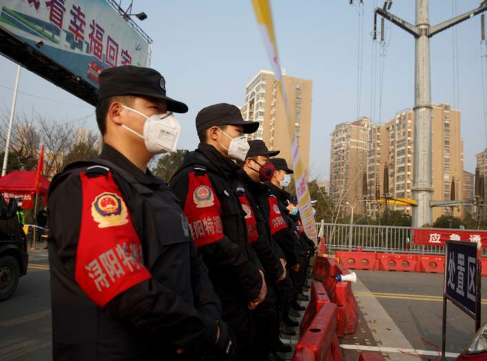 Police stand at a checkpoint at the Jiujiang Yangtze River Bridge that crosses from Hubei province in Jiujiang, Jiangxi province, China, as the country is hit by an outbreak of a new coronavirus, January 31, 2020.