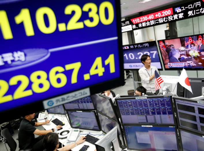 FILE PHOTO: Employees of a foreign exchange trading company in Tokyo, Japan, June 12, 2018. REUTERS/Issei Kato/File Photo