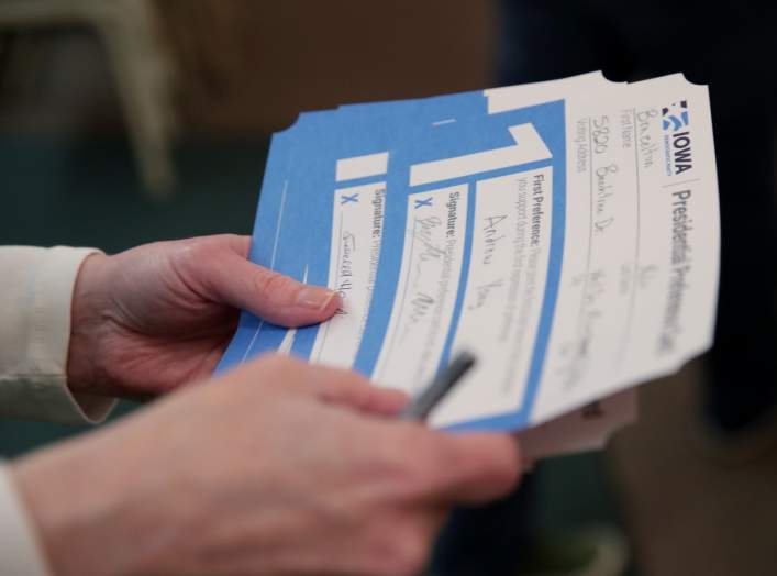 An Iowa Caucus precinct worker counts Iowa Democratic Caucus paper ballots as caucus votes are tallied after a Democratic presidential caucus at West Des Moines Christian Church in West Des Moines, Iowa, U.S., February 3, 2020.