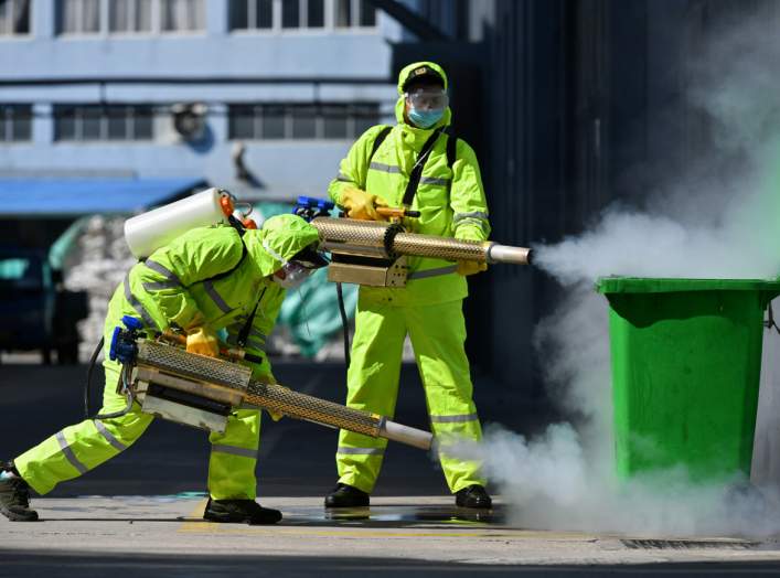 Volunteers in protective suits disinfect a factory with sanitizing equipment, as the country is hit by an outbreak of the novel coronavirus, in Huzhou, Zhejiang province, China February 18, 2020. China Daily via REUTERS
