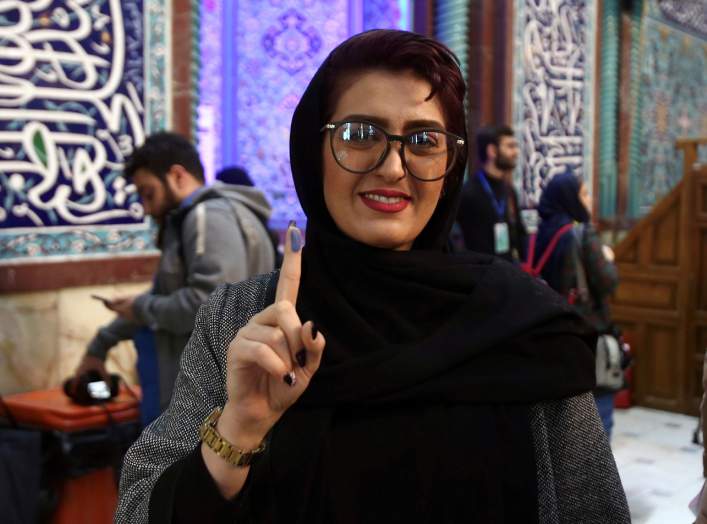 A woman shows her ink-stained finger after she casted her vote during parliamentary elections at a polling station in Tehran, Iran February 21, 2020. Nazanin Tabatabaee/WANA (West Asia News Agency) via REUTERS 