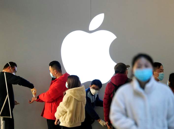 People wearing protective masks wait for checking their temperature in an Apple Store, in Shanghai, China, as the country is hit by an outbreak of the novel coronavirus, February 21, 2020. REUTERS/Aly Song