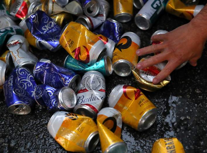 A recycled waste collector picks up beer cans during carnival block party “Unidos do Swing” in Sao Paulo, Brazil, February 24, 2020. REUTERS/Amanda Perobelli