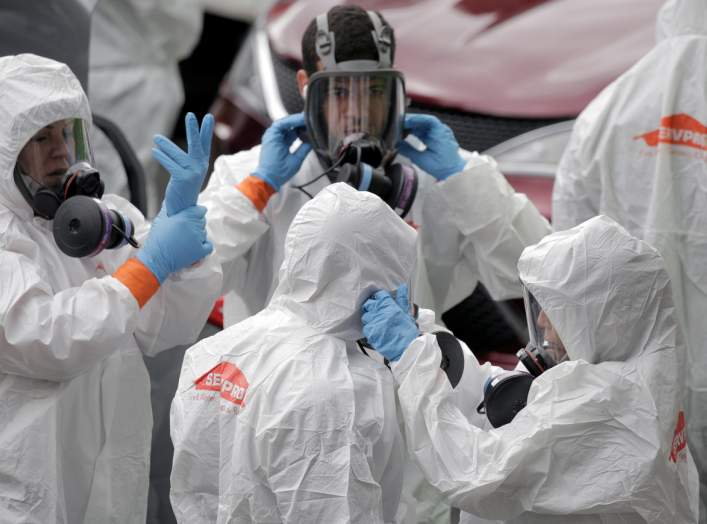 Members of a cleaning crew prepare to enter the Life Care Center of Kirkland, the Seattle-area nursing home at the epicenter of one of the biggest coronavirus outbreaks in the United States, in Kirkland, Washington, U.S. March 12, 2020. REUTERS/David Ryde