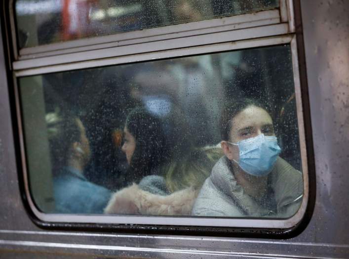 A woman wears a face mask on the subway as the coronavirus outbreak continued in Manhattan, New York City, New York, U.S., March 13, 2020. REUTERS/Andrew Kelly