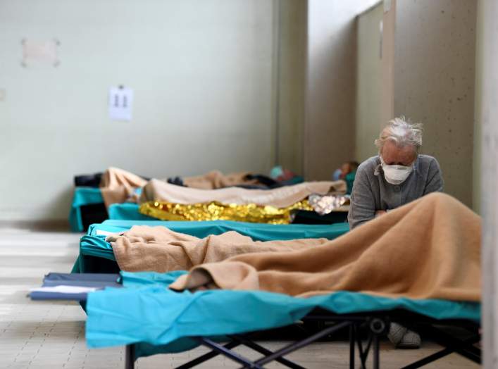 A patient is seen sitting inside the Spedali Civili hospital in Brescia, Italy March 13, 2020. REUTERS/Flavio Lo Scalzo