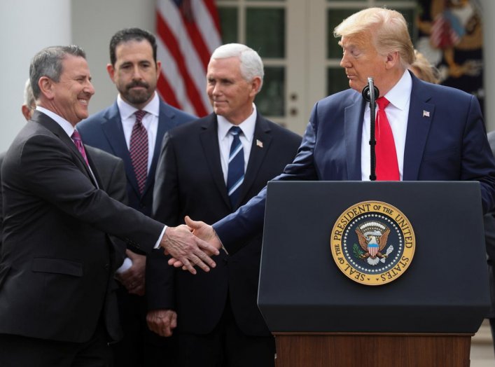 Brian Cornell, the Chairman and CEO of Target Corporation, reaches out and shakes hands with U.S. President Donald Trump after the president declared the coronavirus pandemic a national emergency during a news conference in the Rose Garden of the White Ho