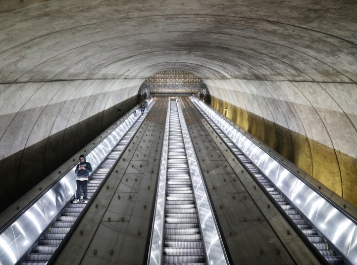 People descend down the Bethesda Metro train station escalator at commuter rush hour, as Governor Larry Hogan (R-MD) ordered the shutdown of all bars and eateries in the state due to the coronavirus disease (COVID-19) in Bethesda, Maryland, U.S., March 16