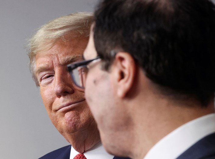 U.S. President Donald Trump reacts as he listens to Treasury Secretary Steven Mnuchin, chief White House negotiator in ongoing talks with the U.S. Senate regarding coronavirus economic aid legislation, during the coronavirus task force daily briefing at t