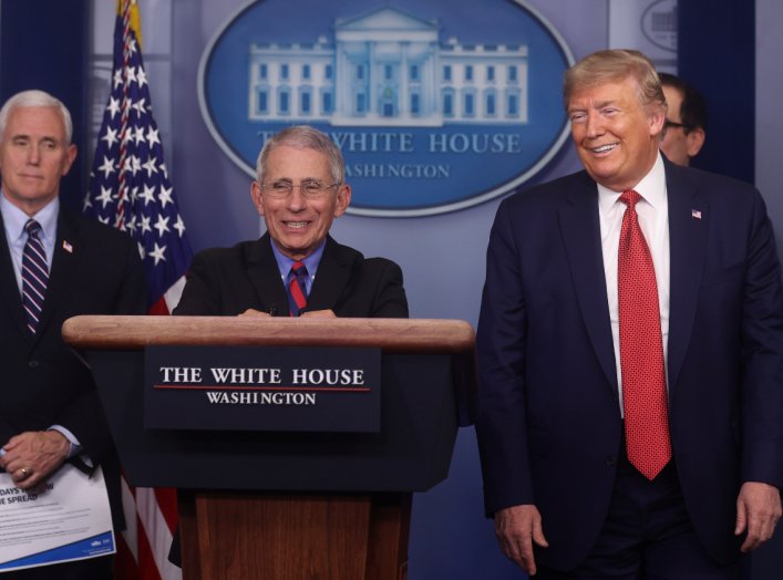 Dr. Anthony Fauci, Director of the National Institute of Allergy and Infectious Diseases, smiles as he addresses the coronavirus task force daily briefing with Vice President Mike Pence and President Donald Trump at the White House in Washington, U.S., Ma